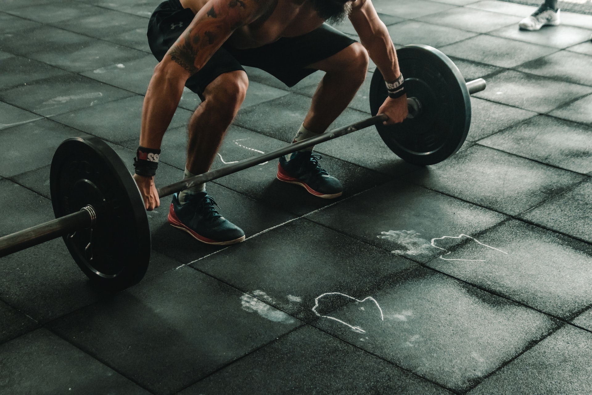 A member of Bondi Health and Fitness trying to life the weights